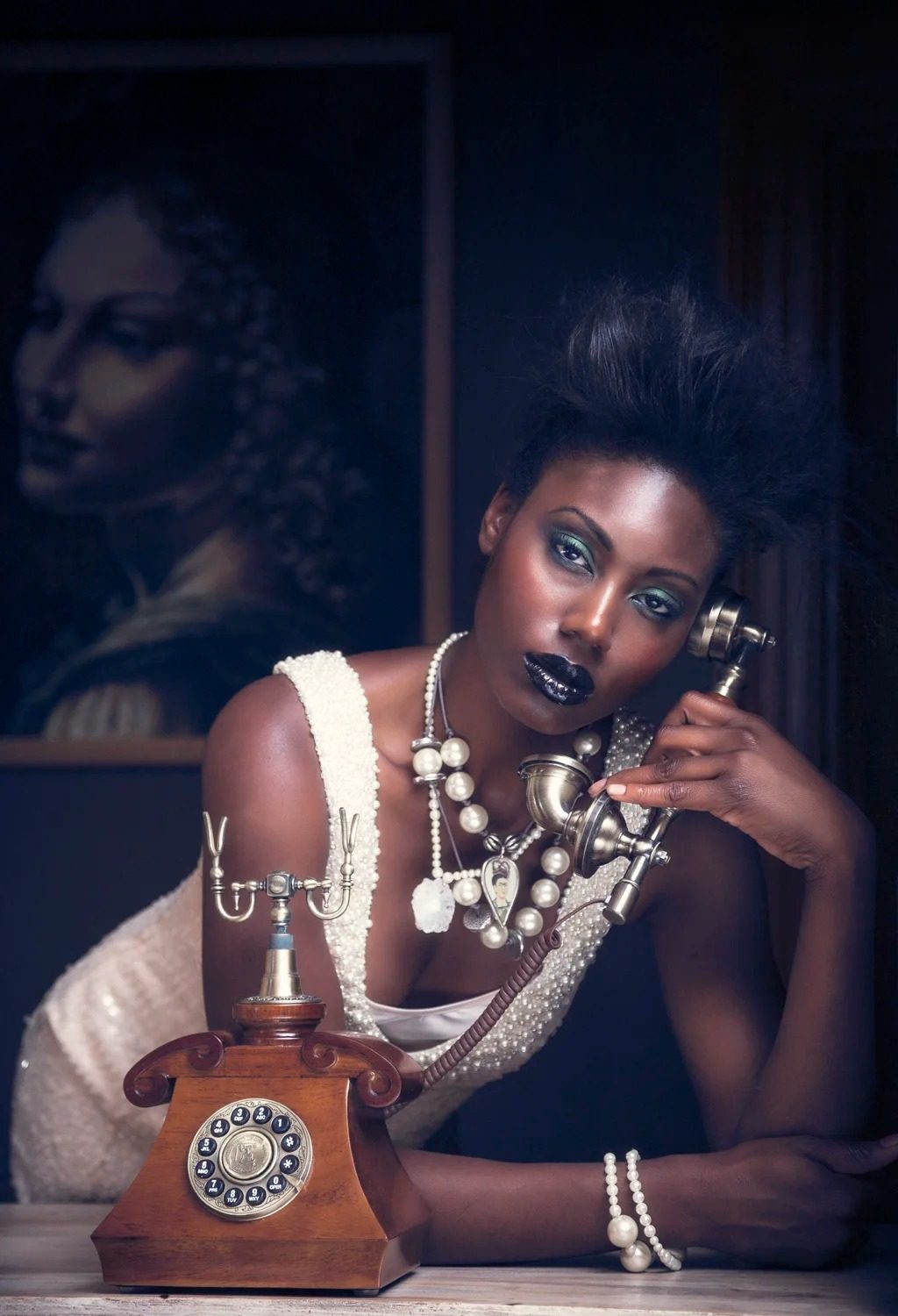 Styled editorial portrait with vintage telephone and pearls