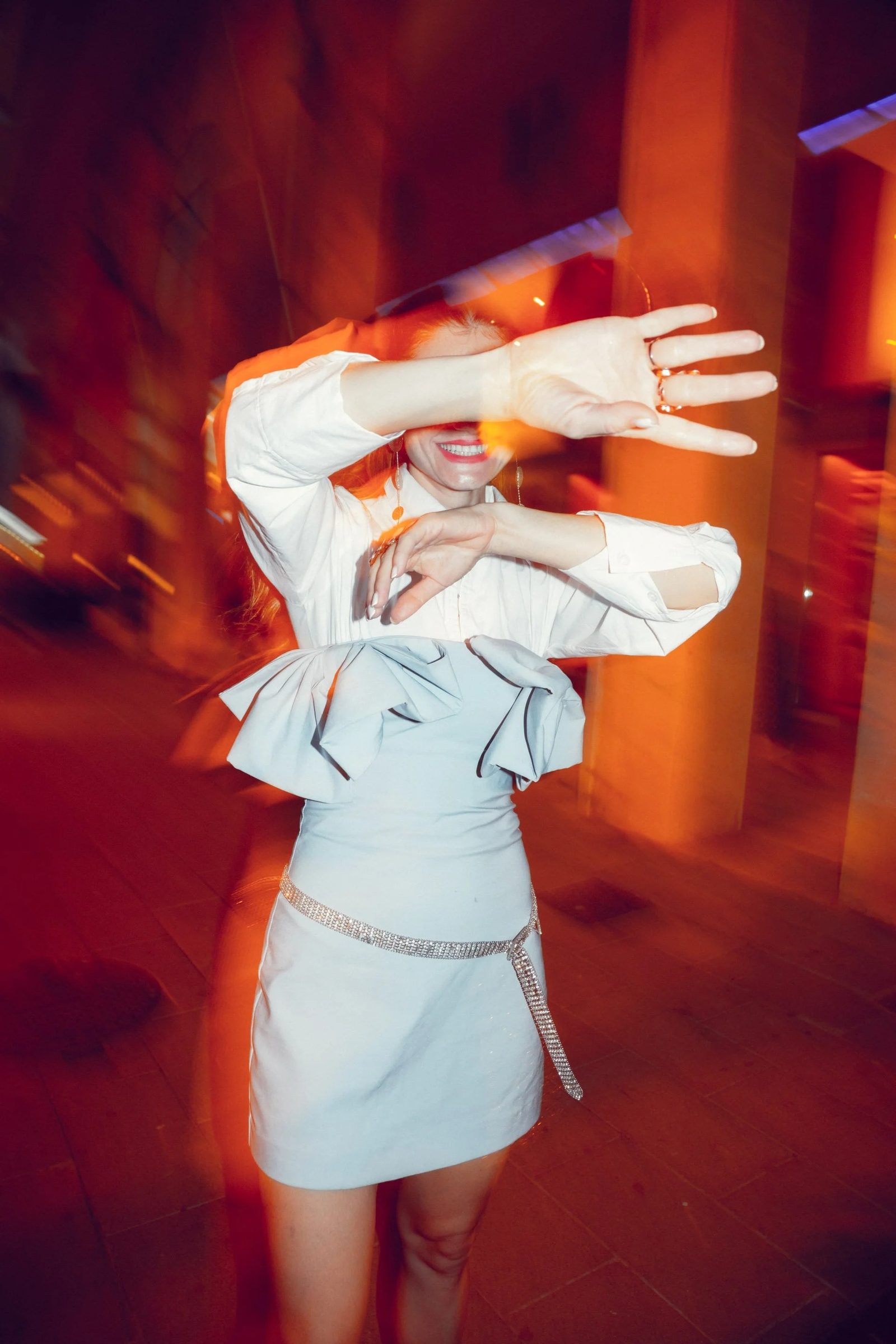 Flash-lit night portrait, motion blur, editorial energy